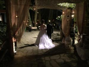 a bride walking down the aisle at a wedding at Margaret's Island Hotel in Naousa