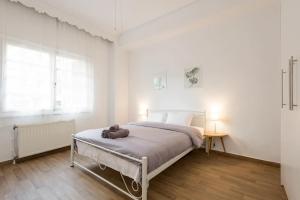 een slaapkamer met een bed met een teddybeer erop bij Saint Dimitrios Central Apartment 100sqm. in Thessaloniki