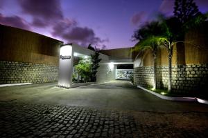 a building with a sign on the side of it at Raru's Motel Via Costeira (Adult Only) in Natal