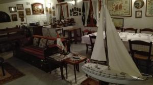 a small sail boat on a table in a restaurant at B&B "Il Cantastorie" Casa Molinari-Boldrini - Room & breakfast in Castelfranco Emilia