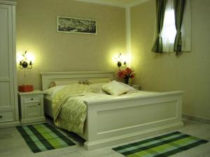 a bedroom with a bed and two lights on the wall at Eco-selo Grabovica in Grabovica