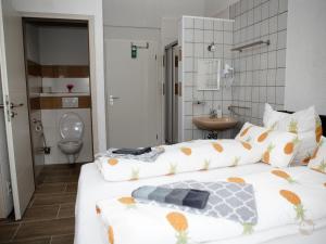 a hotel room with two beds and a bathroom at Bianca`s Hotel Restaurant in Lörrach