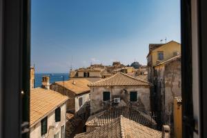 a view from a window of a city with roofs at City walls sea view in Corfu Town