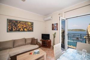 a living room with a couch and a television at City walls sea view in Corfu Town