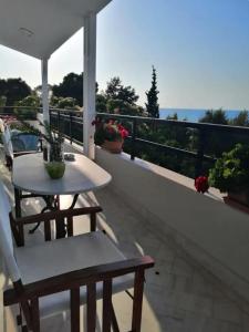 a balcony with a table and chairs on a balcony at Sea Side Villa Alexandra in Alissos