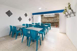 a dining room with blue chairs and tables at Ayenda 1055 Agora INN Corferias in Bogotá