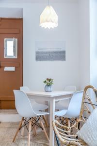 a dining room with a white table and chairs at Renovated Typical Baixa Apartment, By TimeCooler in Lisbon