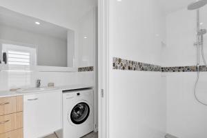 a white laundry room with a washer and dryer at Day Dreaming in Point Lookout