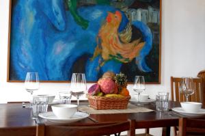 a table with a basket of vegetables and wine glasses at Ocean Breeze Alcalá in Alcalá