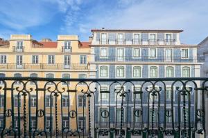 a large building with a fence in front of it at Casa Portuguesa Prata 173 in Lisbon