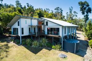 a house on the side of a hill at MANDALAY ESCAPE, SECLUSION & SERENITY WITH A POOL in Airlie Beach