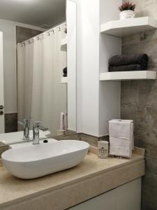 a bathroom with a white sink and a mirror at star apartment olivos in Olivos