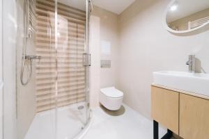 a bathroom with a shower and a toilet and a sink at Unique Apartment-City Center-1 bedroom-3min-Center in Krakow