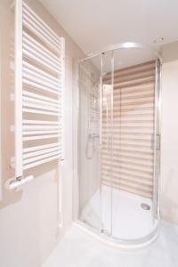a glass shower in a bathroom with a window at Unique Apartment-City Center-1 bedroom-3min-Center in Krakow
