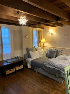 a bedroom with two beds and a table with a lamp at Innkeeper's Place B&B in Stafford Springs