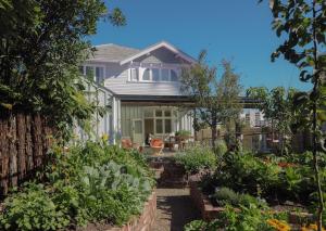 a house with a garden in front of it at Luxury Eco Villa in Christchurch