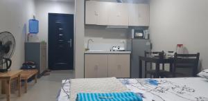 Habitación con cocina, cama y mesa. en Your Holiday Home( Studio, King Size Bed), en Mactan