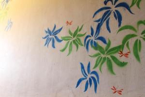 eine Wand mit blauen Blumen darauf in der Unterkunft Harrys Oceanhouse 2 Pacitan in Pacitan
