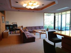 a living room with a couch and a table at Hiranoya in Takayama