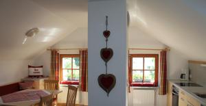 a kitchen with two hearts hanging on the wall at Appartementhaus Lechnerhof in Brunico