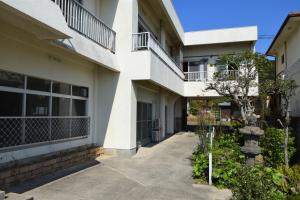 a building with a walkway in front of it at Uminoyado Yamawo in Tonosho