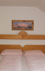 a bedroom with two beds and a mirror on the wall at Appartementhaus Lechnerhof in Brunico