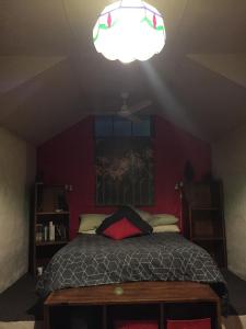 a bedroom with a bed and a ceiling with a light at Rossmount Rural Retreat in Goomboorian