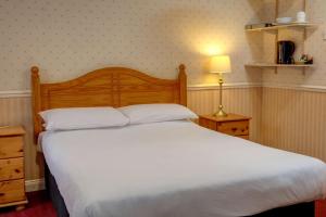 a bedroom with a large white bed and a lamp at Sure Hotel by Best Western Reading in Reading