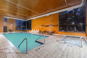 a large swimming pool in a large building at Baymont Inn & Suites by Wyndham Mukwonago in Mukwonago