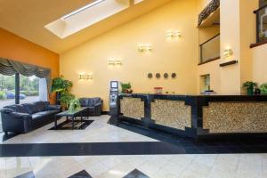 a lobby with a bar in the middle of a building at Days Inn by Wyndham Hillsborough in Hillsborough