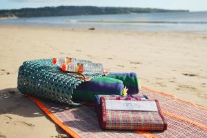 a pile of towels and water bottles on a beach at Anja Jimbaran in Jimbaran