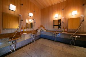 
a bath room with a sink and a mirror at Ohanabo in Kyoto
