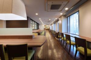 a dining room with a long table and chairs at Keio Presso Inn Ikebukuro in Tokyo