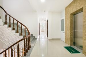 a hallway of a house with stairs and a door at Jupiter Hotel in Vung Tau