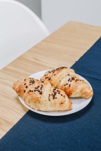 two pieces of bread on a plate on a table at Beautiful and Unique Apartment on the 3rd Floor-MEZZANINE in Kraków