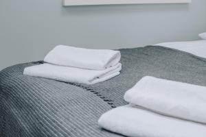 a pile of towels sitting on top of a bed at Beautiful and Unique Apartment on the 3rd Floor-MEZZANINE in Kraków