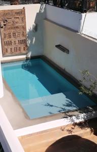 a swimming pool with blue water next to a building at Riad Bab aylen - Piscine Roof Top chauffée in Marrakesh