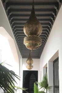 two chandeliers hanging from a ceiling in a room at Riad Bab aylen - Piscine Roof Top chauffée in Marrakesh