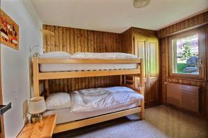 a bedroom with two bunk beds and a desk at Skirama 018 in Verbier