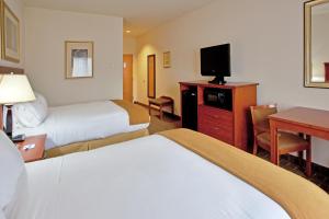 a hotel room with two beds and a flat screen tv at Holiday Inn Express & Suites - Hardeeville-Hilton Head, an IHG Hotel in Hardeeville