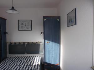 a bedroom with a bed and a blue cabinet at résidence de la plage in Jullouville-les-Pins