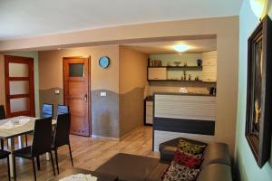 a living room and kitchen with a couch and a table at Domki Beskid in Rzyki