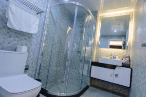 a bathroom with a shower and a toilet at CA&SA Serviced Apartment in Phnom Penh