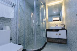 a bathroom with a shower and a toilet and a sink at CA&SA Serviced Apartment in Phnom Penh