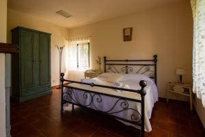 a bedroom with a bed and a green cabinet at Casale Il Trecento in Castiglion Fiorentino +47 photos