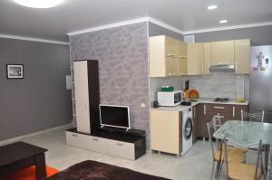 a small kitchen with a table and a microwave at Apartments in the heart of Kursk on Radischeva street in Kursk