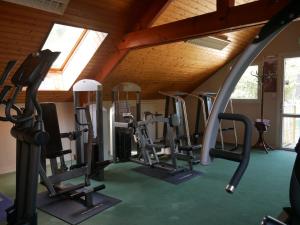a gym with rows of treadmills and ellipticals at Camping Officiel Siblu Les Pierres Couchees in Saint-Brevin-les-Pins