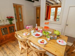 a kitchen with a wooden table with food on it at Sandy Cottage in Linton