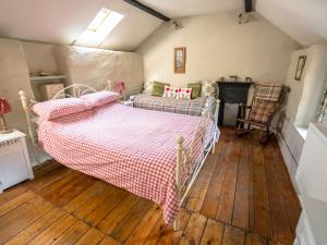 a bedroom with two beds and a fireplace at The Wilderness in Bromlow