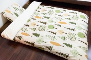 a pillow with a pattern of fruits and vegetables at Luxes Hiroshima2030 ラクセス ヒロシマ2030 in Hiroshima